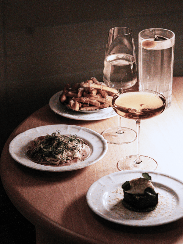 plates of food and glasses of wine and water