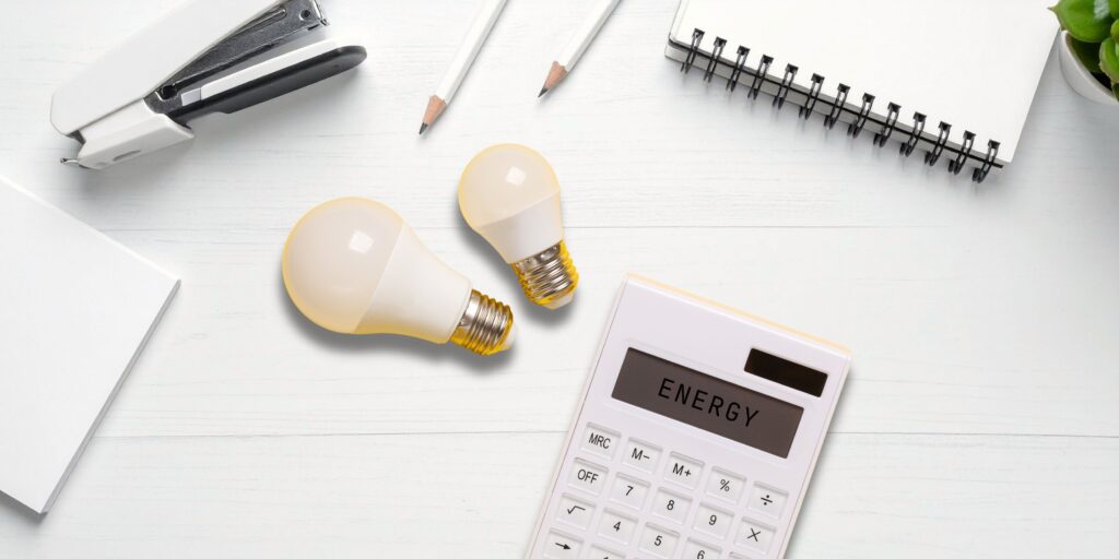 Energy Efficiency calculator, lightbulbs and notepads