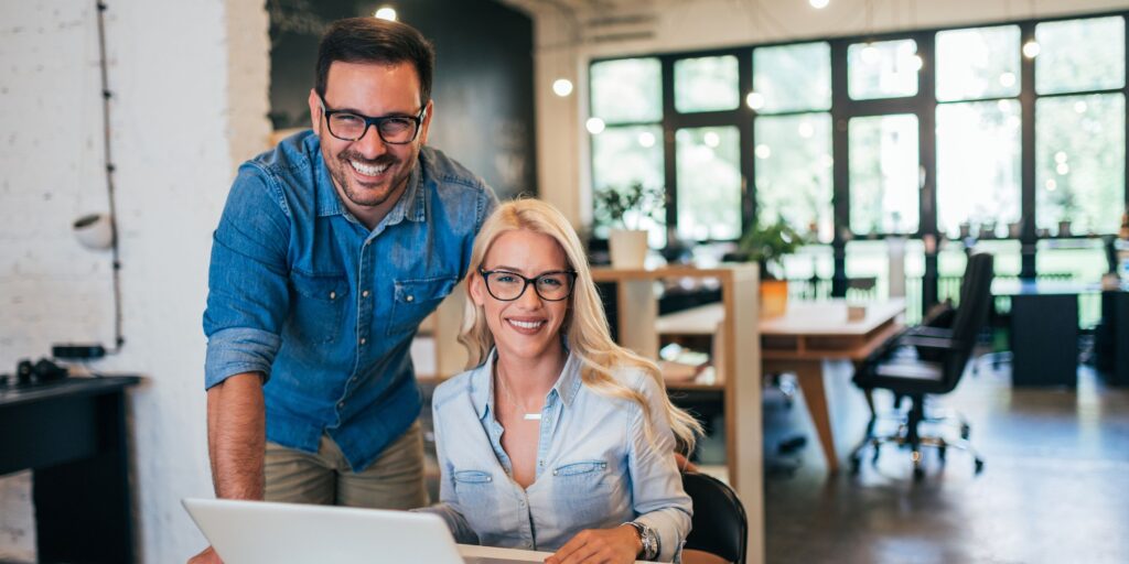 Happy small business owners at a laptop